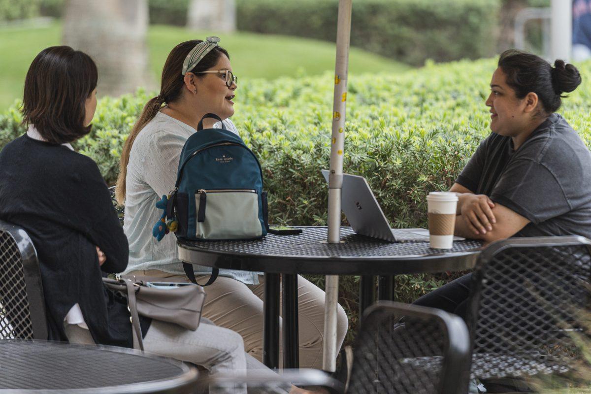 Nayeli Cerano (right), a pre-nursing student at Riverside City College, tolerates a pair of self identified "Non-denominational Christians representing the Church of God" who, along with several others, have been all over the RCC campus today approaching students and engaging in proselytization.

The group of proselytizers admitted to not having administrative permission to be on campus approaching students, but claimed that they knew a student named "Stacy" who "they were helping" although they could not come up with a last name, or a major for this alleged student.

Photo by Stephen Day, Viewpoints