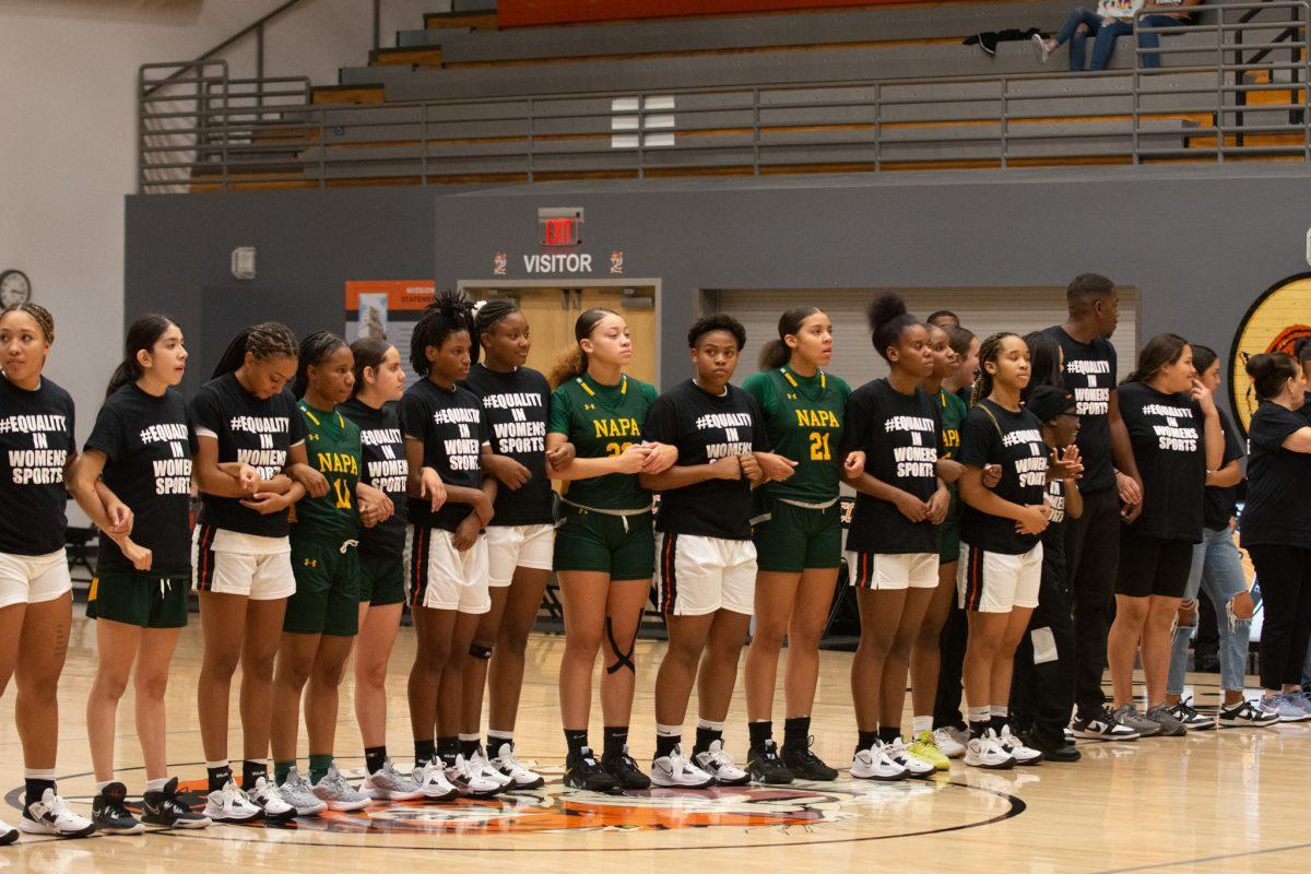 Members from both Riverside City College and Napa Valley link arms before the National Anthem in recognition of Title IX on Nov. 5. Peter Gibbs | Viewpoints