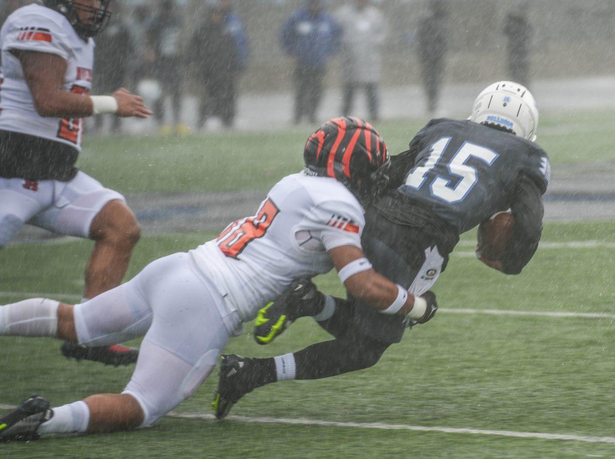 A RCC defender tackles Brian Pierce during the CCCAA state championship game at College of San Mateo on Dec 10. Photo By Stephen Day | Viewpoints