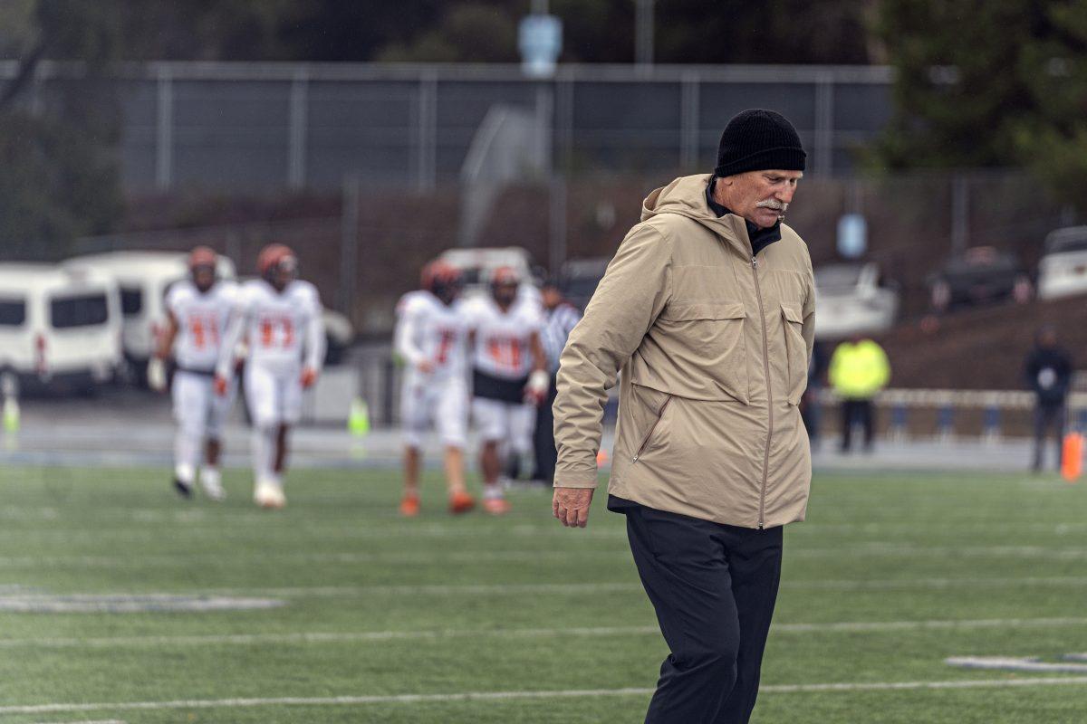 Coach Tom Craft walks the sidelines while the Tigers suffer setback after setback in the windy rain soaked CCCAA Championship game.

The Tigers were defeated 55-0 at College of San Mateo against the Bulldogs on Dec 11.

Photo by Stephen Day, Viewpoints.