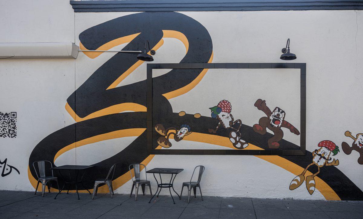 A mural on the outside wall shows the Beignet Spot logo with beignets that have arms and legs and fruity hats on Dec. 13 at the Beignet Spot.

(Photos by Stephen Day |
 Viewpoints)