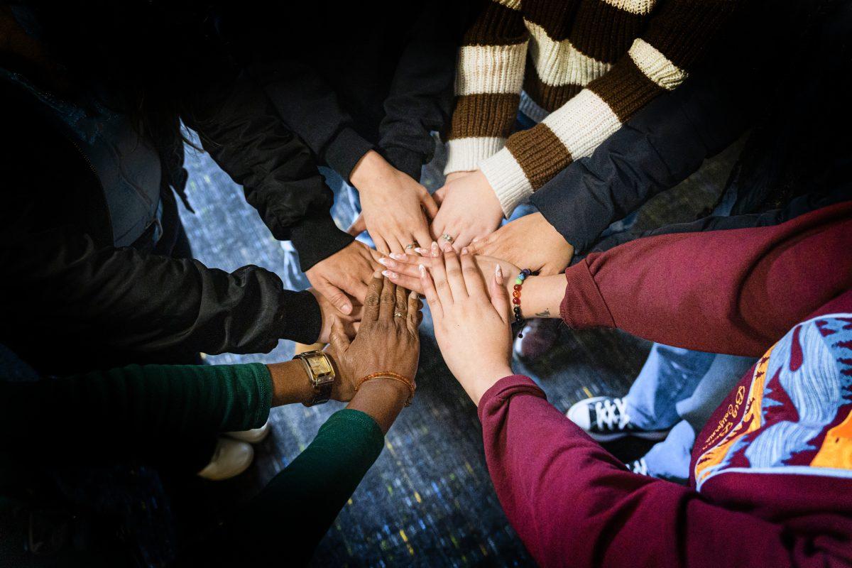 Women put their hands together in support of supporting women's empowerment every day on Mar 22.

Photo by Stephen Day, Viewpoints.