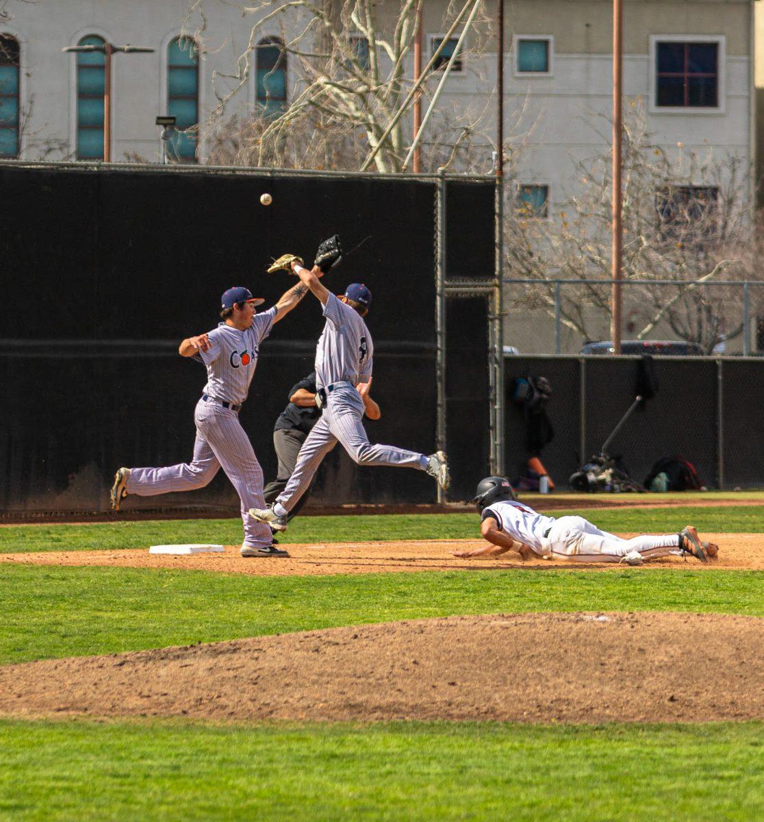 Freshman infielder Robert Phelps slides into third. He would score on a fielding error by Orange Coast College on March 13 at the Evans Sports Complex. Photo by Mathew Acosta, Viewpoints.