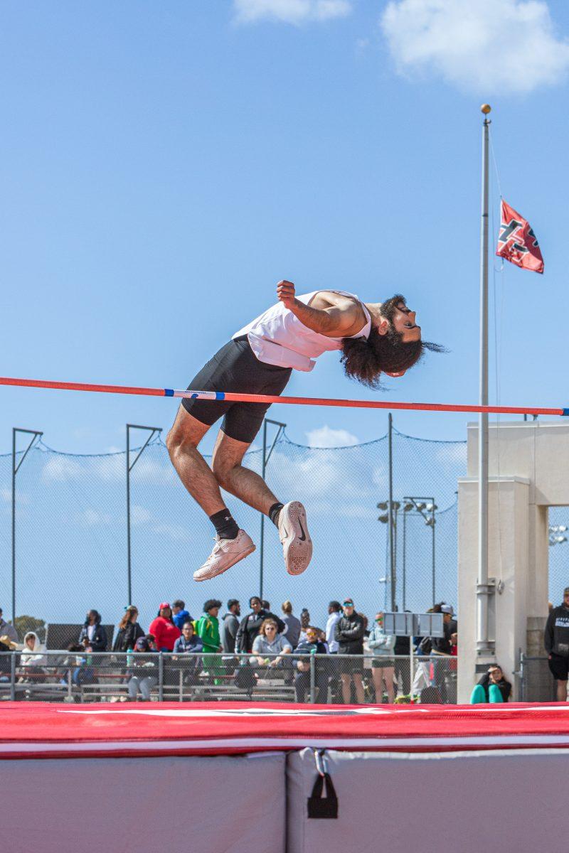 Darius Hill completes a successful high jump at the Aztec Invitational on March 25. Photo by Mathew Acosta, Viewpoints. 