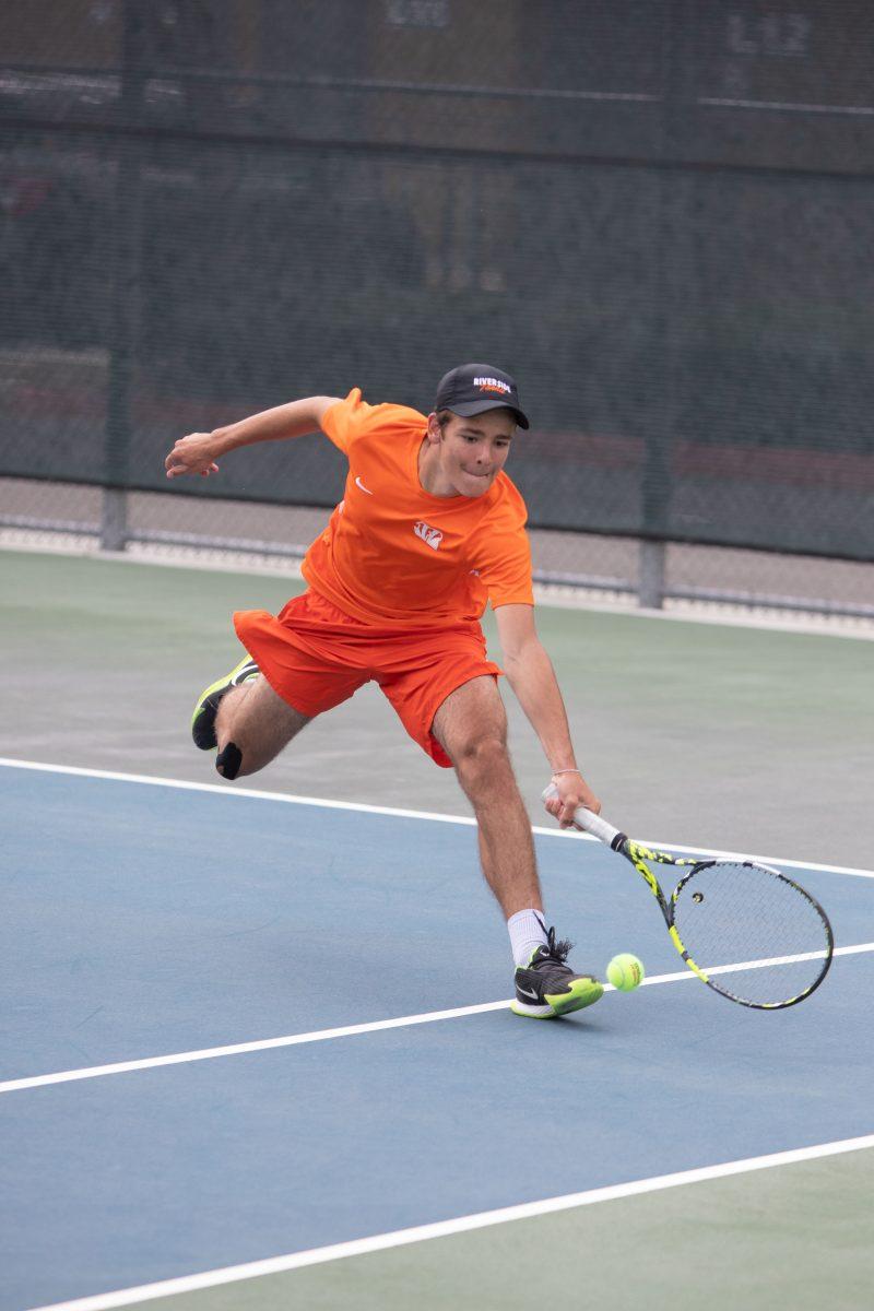 Freshman Raphael Delente fully extends to return a shot. Delente won both the point and the match on March 16. Photo by Ausja Nolan, Viewpoints.