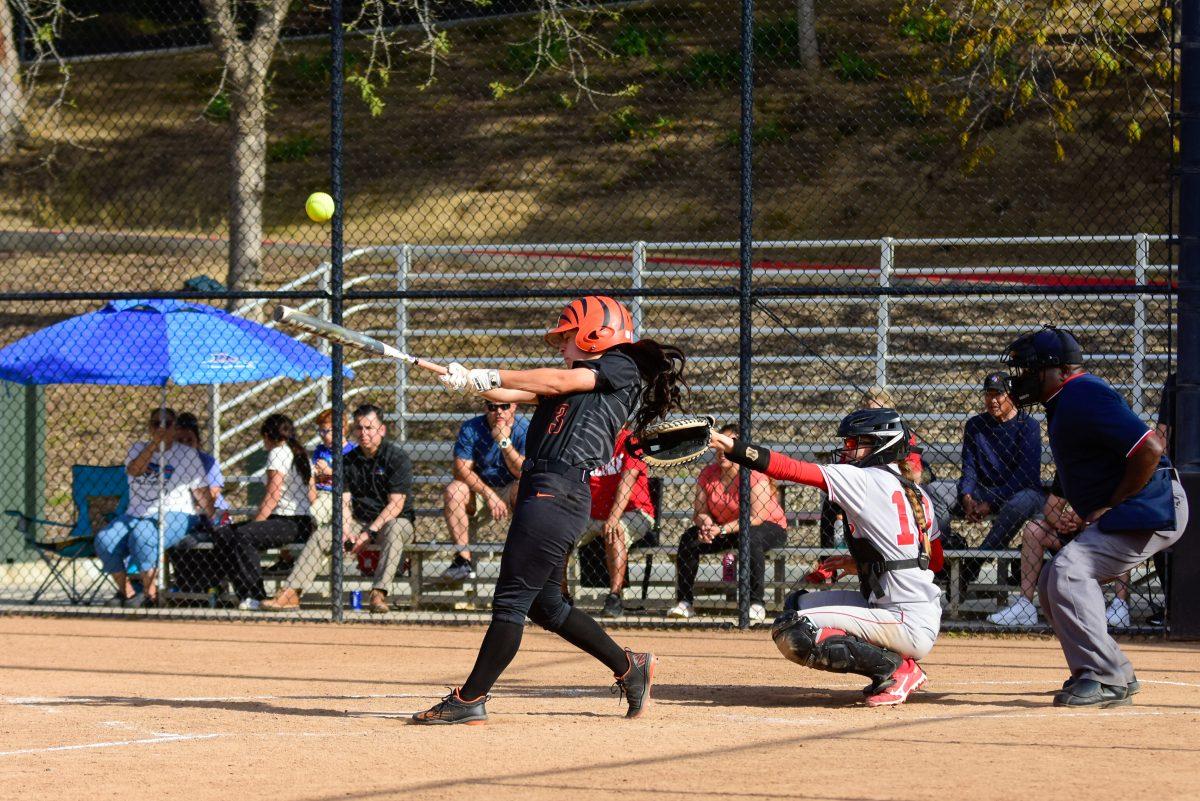 Sophomore Sarah Franco-Colis hits a ball into the air. RCC had four hits against Palomar College on April 11. Photo by Mathew Acosta, Viewpoints.