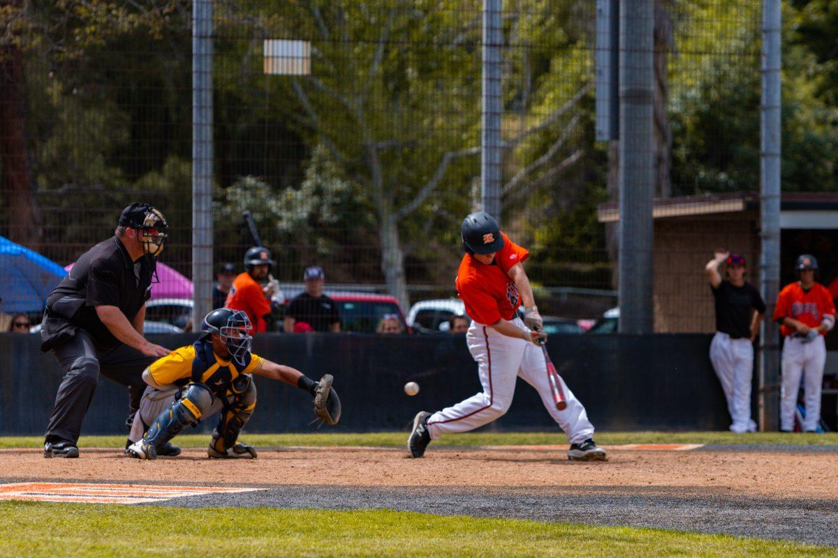 Freshman Ian Carr swings through strike three against Fullerton college on April 22. The Tigers lost 12-1. Photo by Mathew Acosta.