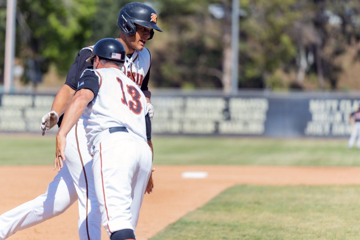 Riverside City College Tiger Matthew Bardowell gets a congratulatory hand slap from Coach Rudy Arguelles after slaming a two run homerun during the game against the Saddleback College Bobcats on April 27.

Tigers defeated the Bobcats 11-8.

Photo by Stephen Day, Viewpoints.