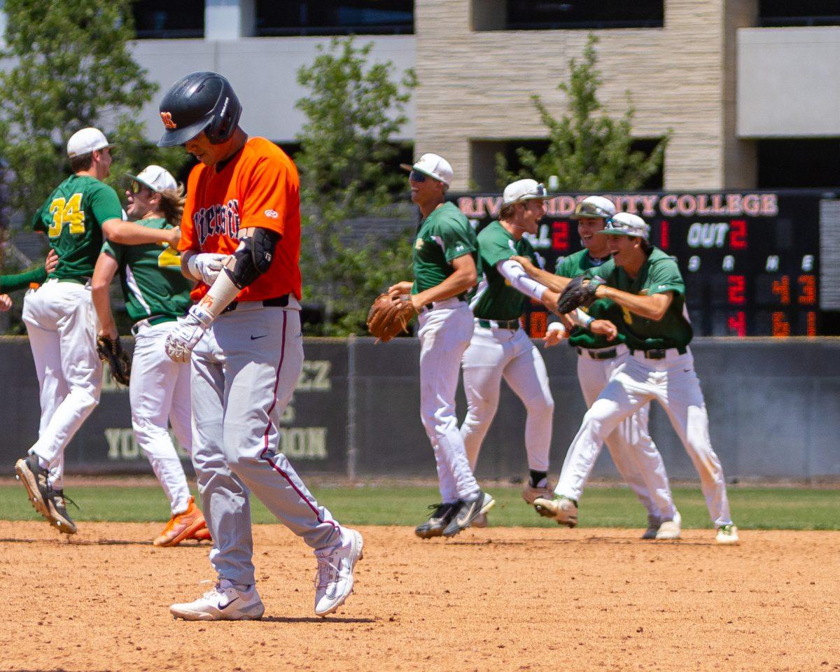 Sebastian Flores hangs his head while Grossmont College players celebrate their sweep over RCC. Photo by Mathew Acosta, Viewpoints.