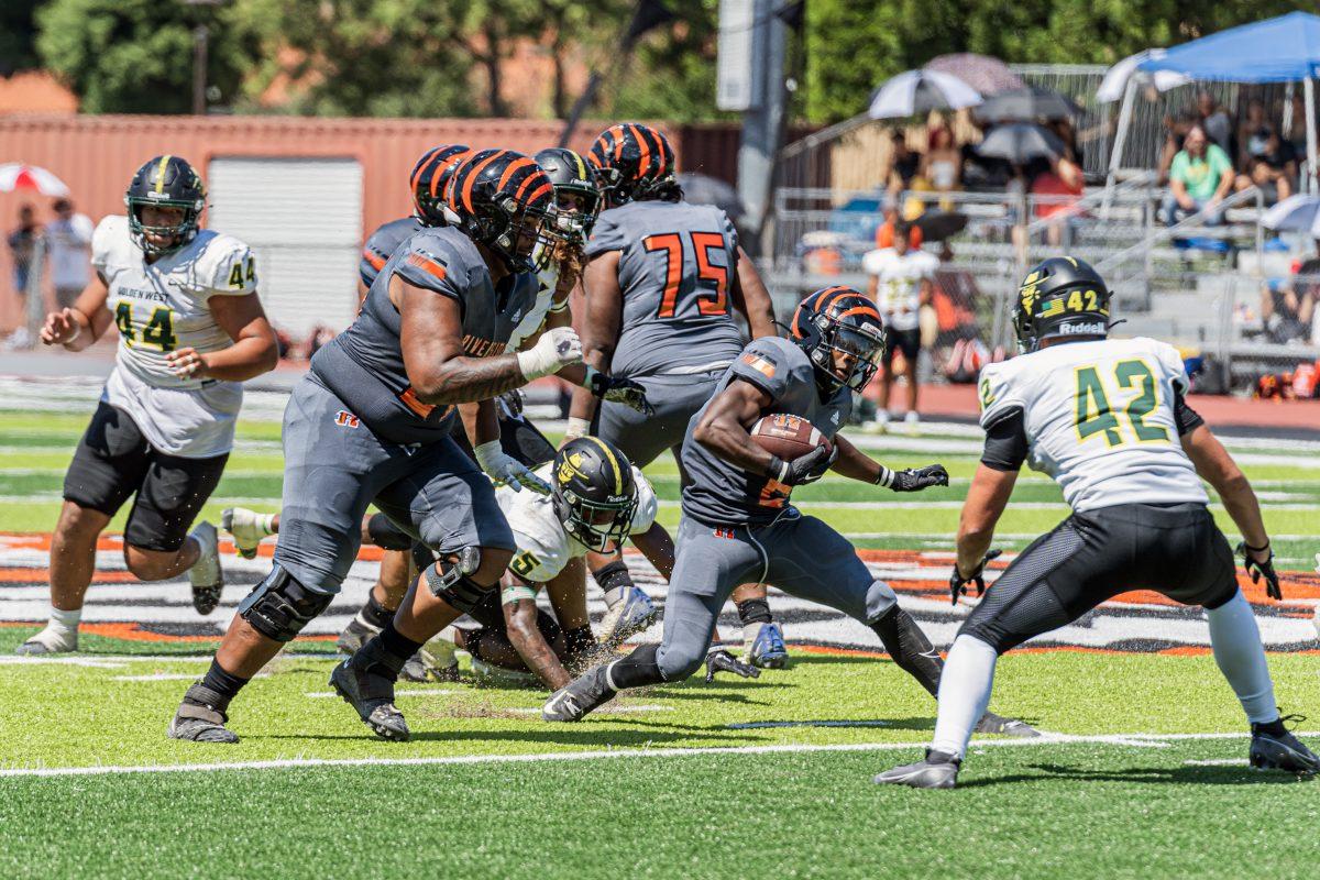 Riverside City College Tiger Bryce Strong pivots on his run to avoid Caine Elroy during the season home opener against Golden West Rustlers at RCC's Wheelock Field on Sept. 9.

Photo by Stephen Day, Viewpoints.