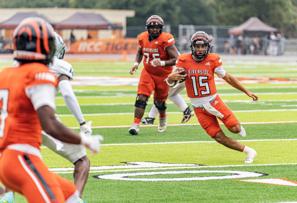 Riverside City Tiger quarterback Jordan Barton spots an opening and takes advantage by running the ball during the Tigers game against El Camino Warriors at Wheelock Stadium on Sept 16.

(Stephen Day, Viewpoints)