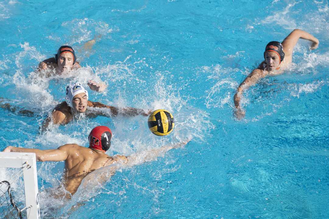 Riverside City College Tiger Goalkeeper Nathan Dulkis rushing to prevent Cypress College Charger attacker from getting the ball during their match up against the Chargers at the RCC Aquatics Center on Oct 18. 