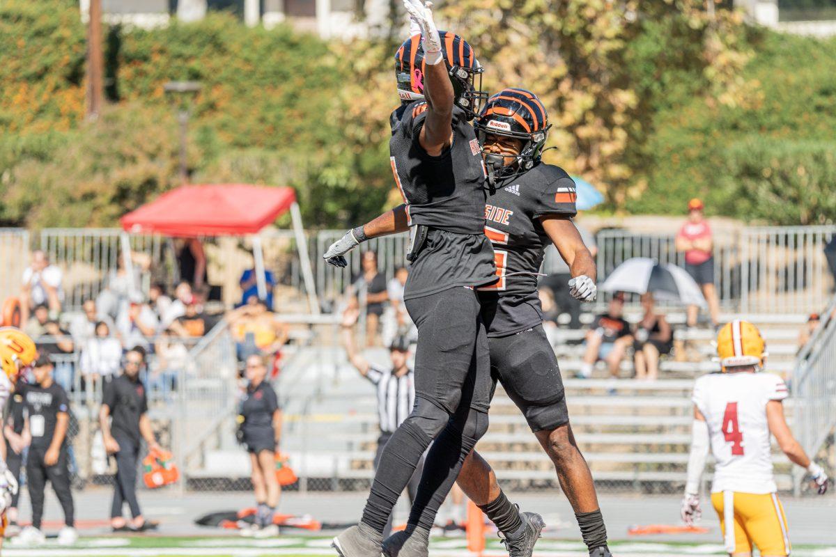 Riverside City College Tigers Ayinde Bankole and Jesse Campbell celebrate a Tiger touchdown during the Tigers match-up against the Saddleback College Bobcats at RCC's Wheelock Stadium on Oct 28.

Tigers defeated the Bobcats 39-0.

Photo by Stephen Day, Viewpoints