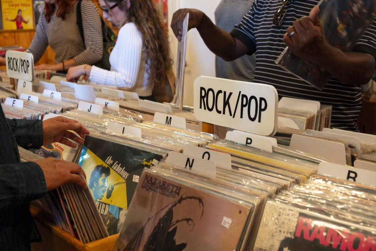 At the busy grand opening of Penrose Record Room, customers browse the records for sale. The shop, located in downtown Riverside, opened on Oct. 28.