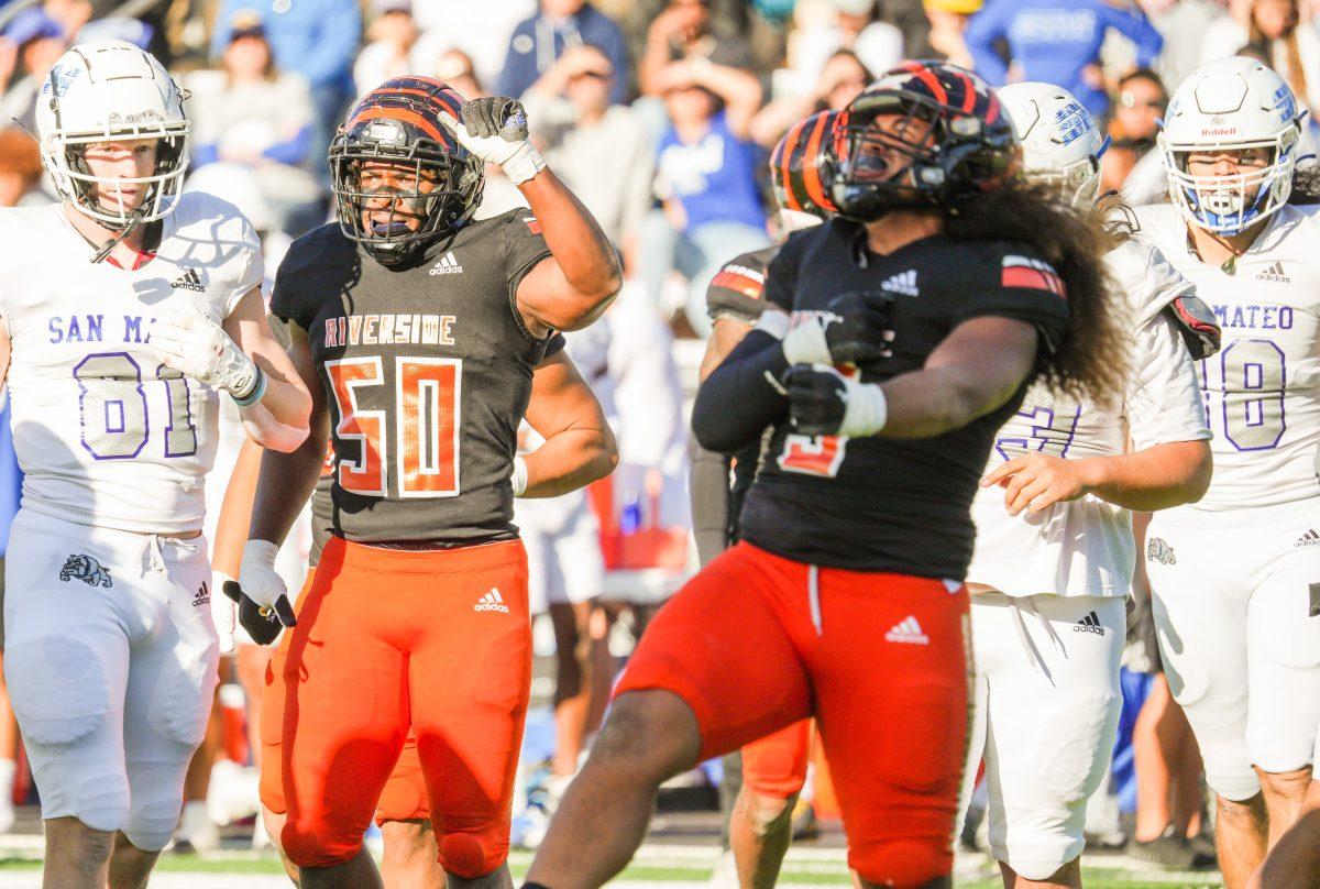 Sophomore linebackers Leo Tupou and Ja'wuan Nickson celebrating a defensive stop in the 3C2A State Championship Game against College of San Mateo at Wheelock Stadium on December 9. Photo by Stephen Day.