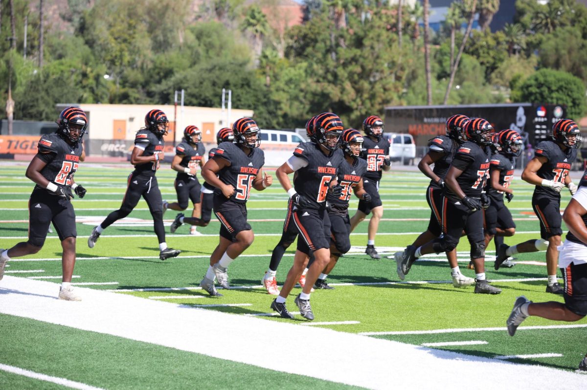 Riverside City College Tigers football players run off the field during their scrimmage on Aug. 25