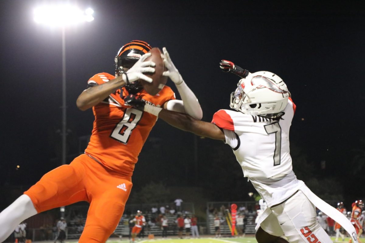 Riverside City College Tiger wide receiver Ross Nickson III battles for the football with Long Beach Viking defensive back Hagen Foreman 