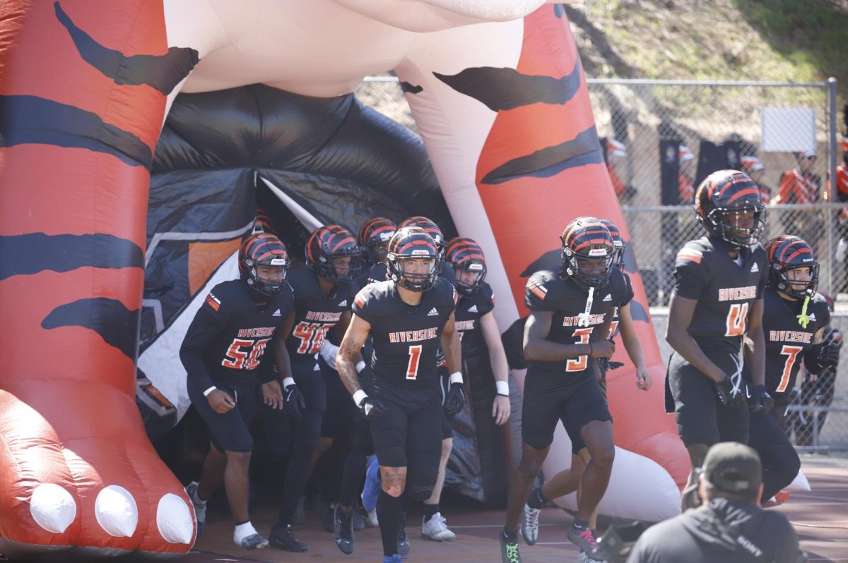 The Riverside City College football team makes an entrance onto the field at the beginning of the game against Palomar College at Wheelock Stadium Sept. 28.