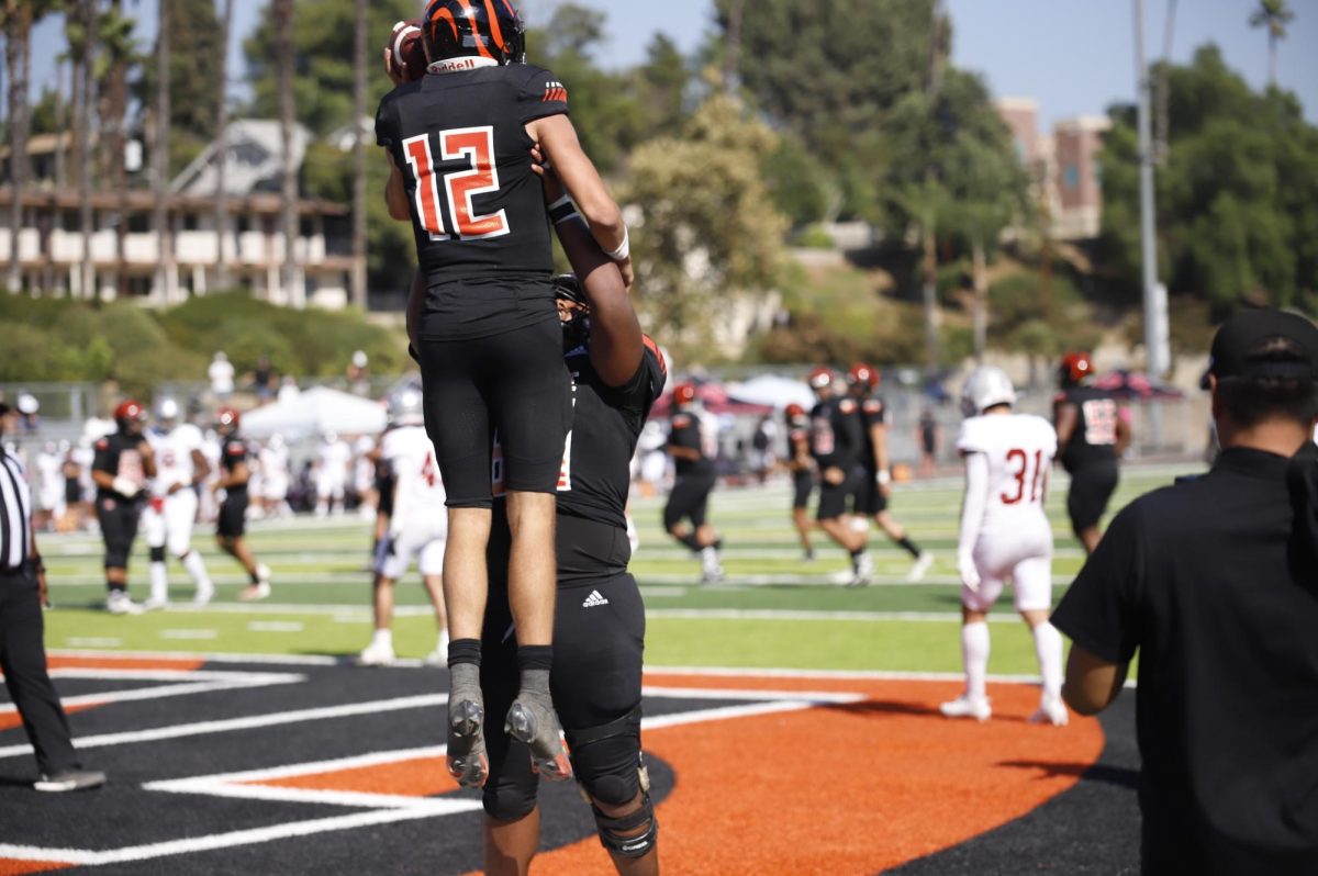 Riverside City College quarterback, Brady Jones, #12, and offensive line Kapeliele Hausia, #69 celebrate after a touchdown at Wheelock Stadium on Sept 28.