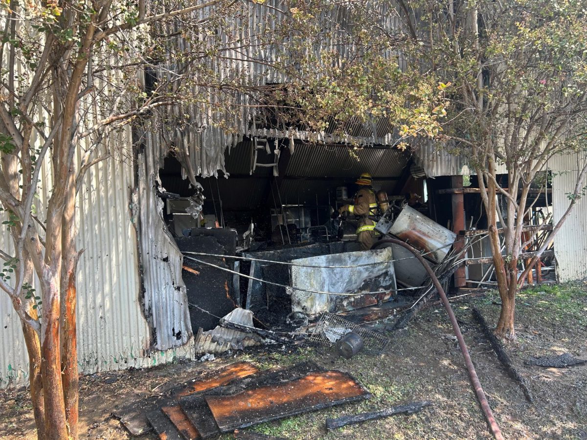 A Riverside City Firefighter finishes knocking down a blaze inside a screen at the Van Buren Drive-In Theater.