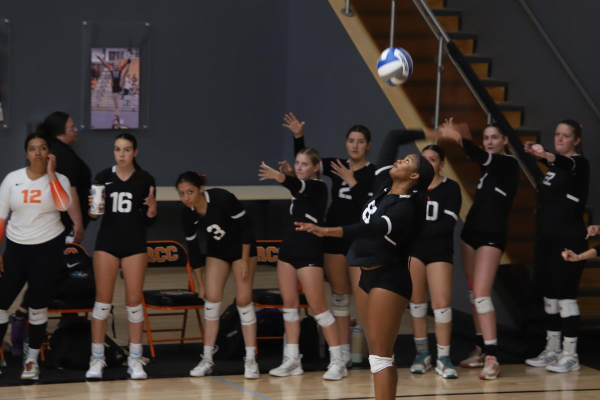 Riverside City College sophomore outside hitter Kilyn Hayes serves the ball as the Tiger sideline watches on at the Wheelock Gymnasium on Oct. 2.