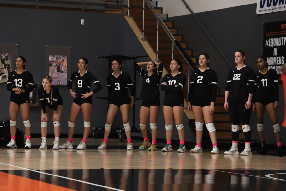 The Riverside City College volleyball team watches on from the sideline during an intense series at Wheelock Gymnasium on Oct. 11