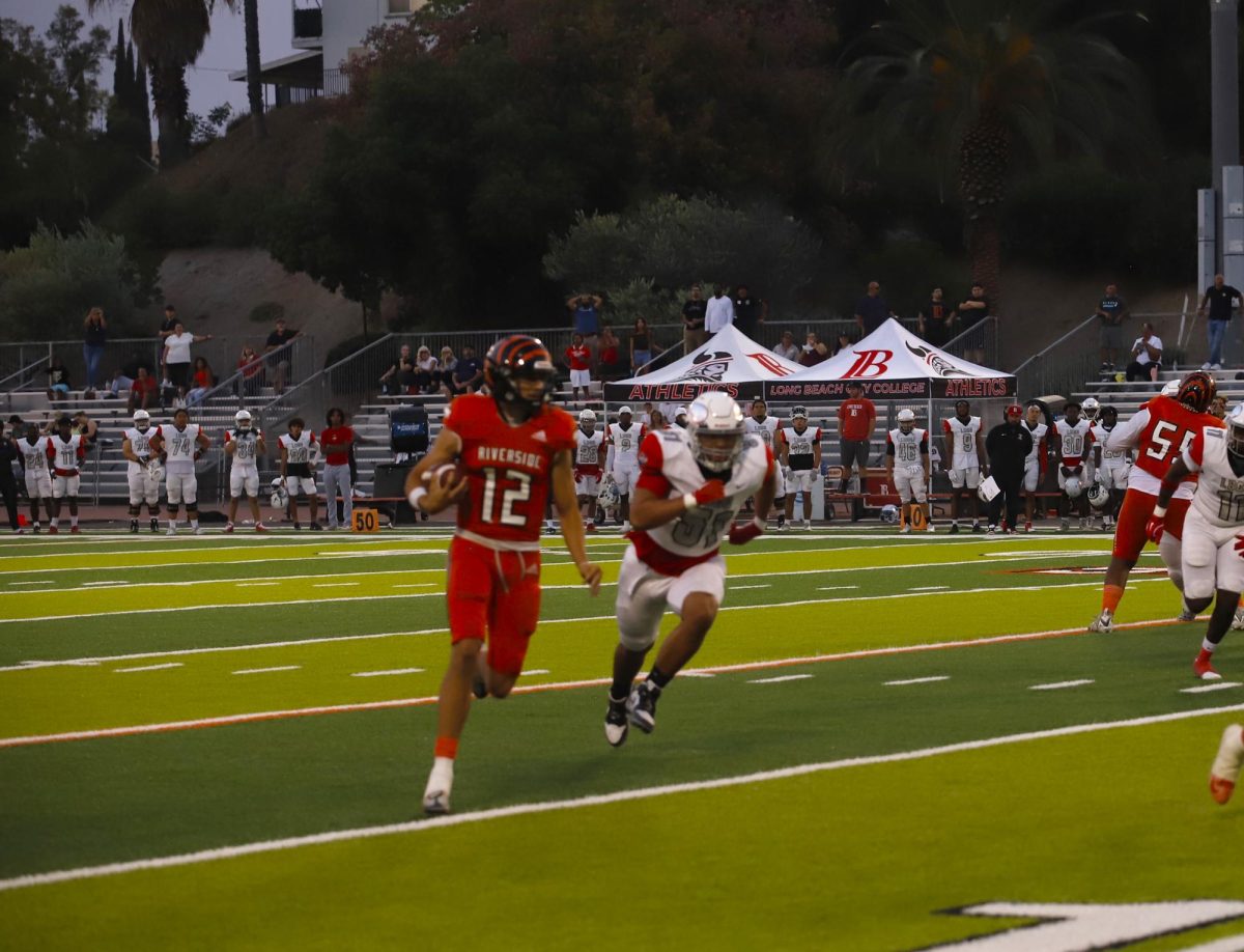 Riverside City College quarterback Brady Jones #12, scrambles out of the pocket against Long Beach City College at Wheelock Stadium Sept. 9. 