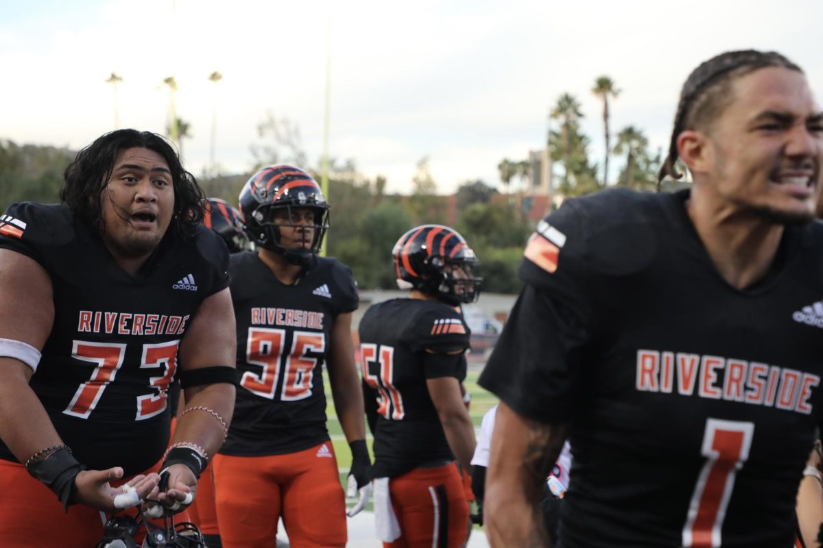 Riverside City College football players Doughlas Teluma, an offensive line, and Jackson Owens, a wide receiver, celebrate a touchdown as they leave the field during the Nov. 30 playoff game against San Diego Mesa College at Wheelock Stadium. 