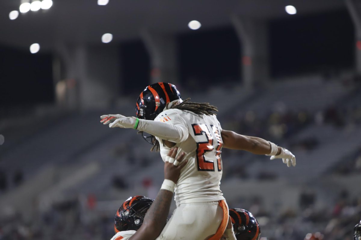 Riverside City College offensive line, Kapeliele Hausia, lifts up running back, Devyne Pearson, to celebrate a touchdown at Hilmer Lodge Stadium Dec. 7.