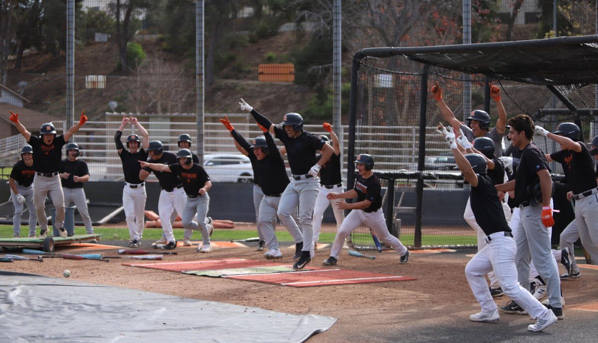 Riverside City College Tigers celebrate after successfully completing a bunting challenge at Evans Sports Complex Jan. 22