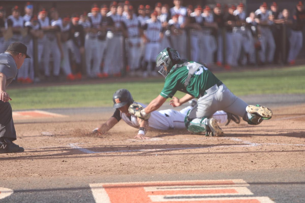 Riverside City College first baseman Dylan Nelson, 15, slides in safely to score a run against Cuesta College at the Evans Sports Complex Jan. 25.