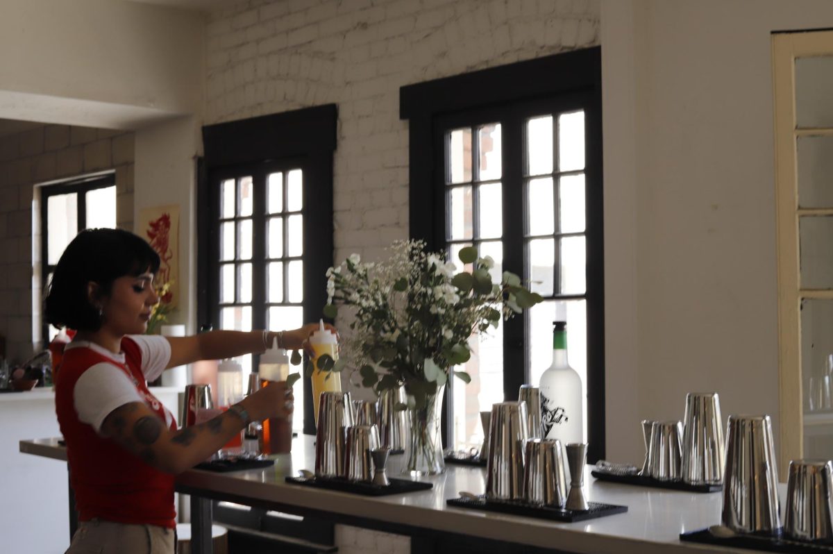 Yolena Ramirez, (28), sets up tables with the necessary materials at her venue in the Life Arts Center.