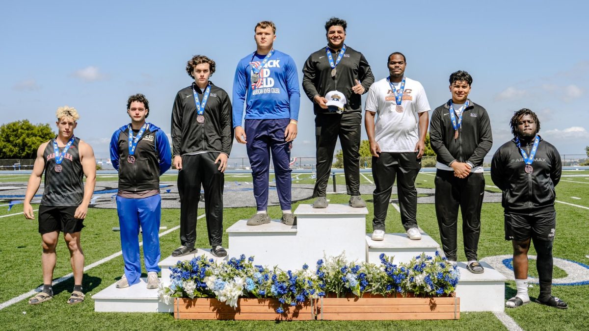 Riverside City College athlete Isaiah Butler stands atop the podium after taking first place in the discus event at the 3C2A state championships at Bulldog Stadium at the College of San Mateo. 