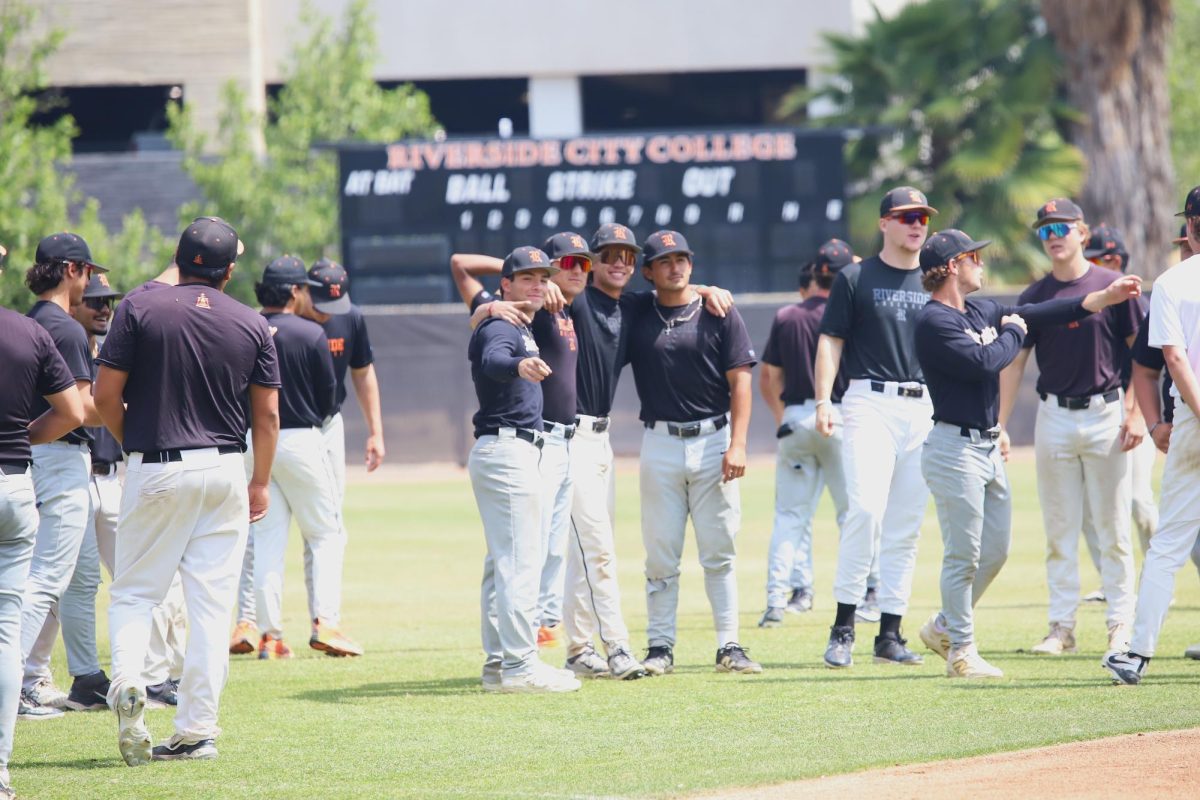 Riverside City College players take a moment to smile before the start of their May 1 practice at Evans Sports Complex