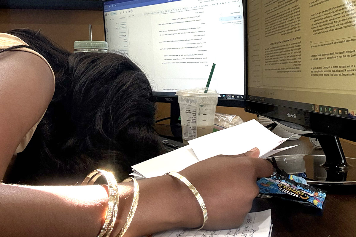 Exhausted student falls asleep while studying for finals.
