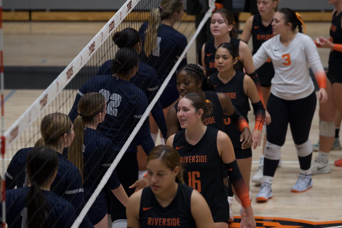 Riverside City College women's volleyball greeting opposing team on Sept. 24.