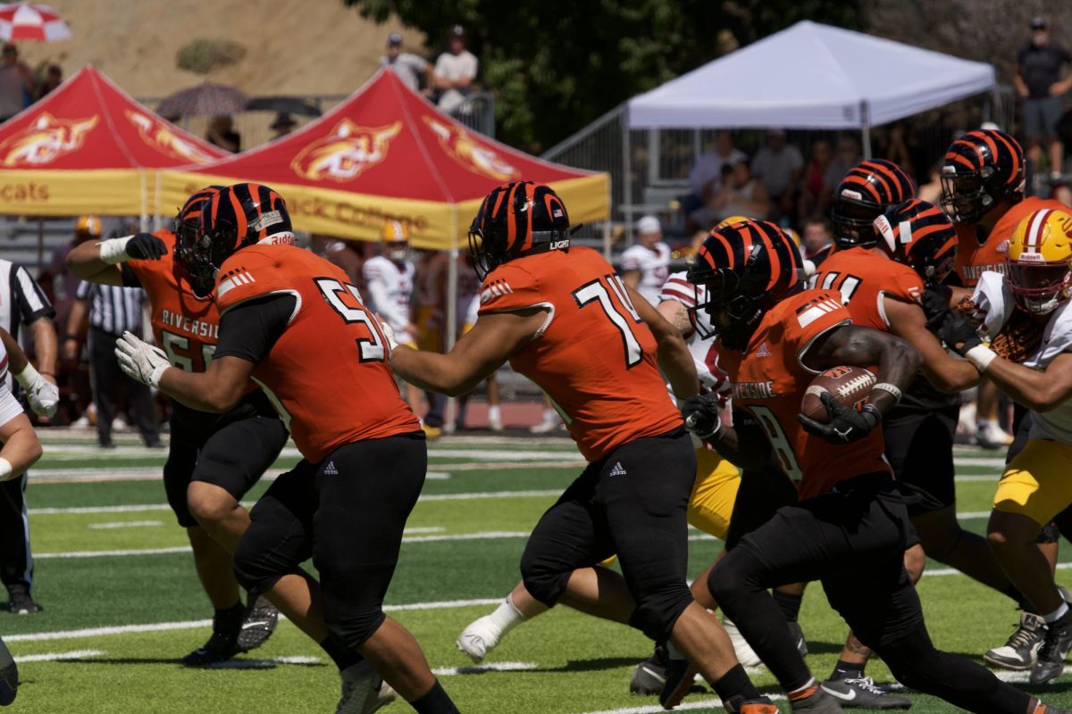Riverside City College offensive Line, Nyko Alvarez #58 and David Trujilo #74, makes a path for running back, Kayvion Sibley #8, to run through during game against Saddleback College on Sept. 20. 