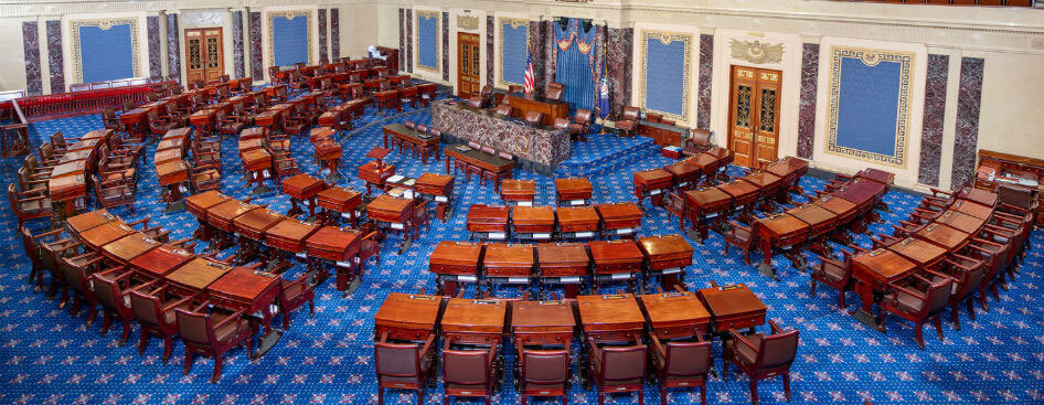 The chamber of the United States Senate as shown with no members present.