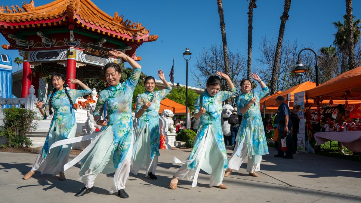 Inland Chineese American Allience Dance Group performs at the Riverside Annual Lunar Festival in front of the Cheech after their official performance on the main stage on Jan. 24.
