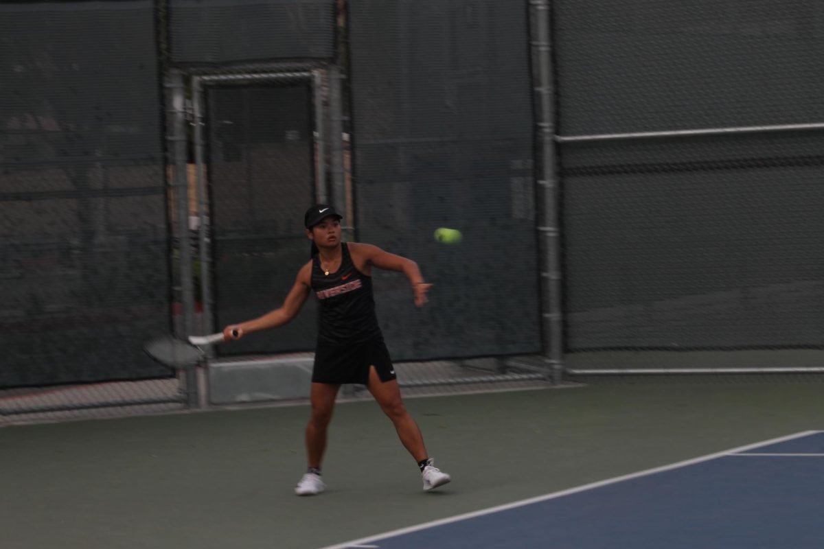 Riverside City College woman's tennis player Fleurdeliz Libutan prepares to strike the ball during her singles match against San Diego City College at RCC on Feb. 5.