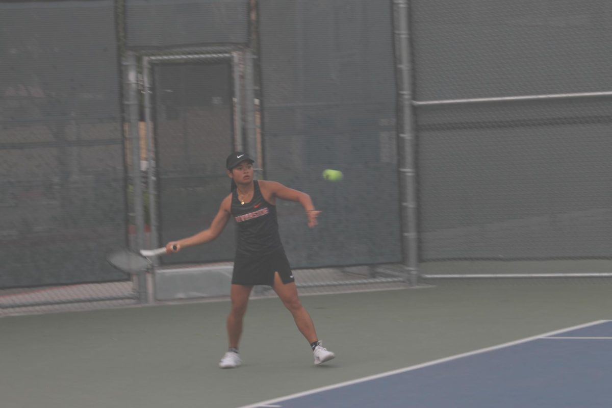 Riverside City College woman's tennis player Fleurdeliz Libutan prepares to strike the ball during her singles match against San Diego City College at RCC on Feb. 5.
